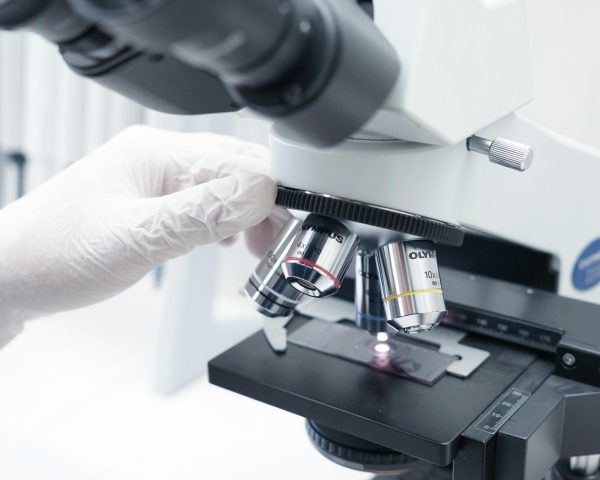 A detailed view of a microscope being used in a modern laboratory.