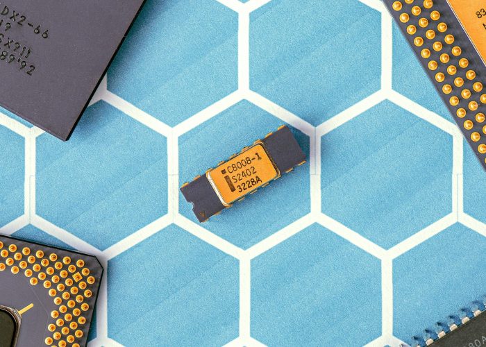 Close-up of various microprocessor chips on a blue hexagonal patterned surface, highlighting electronic technology.